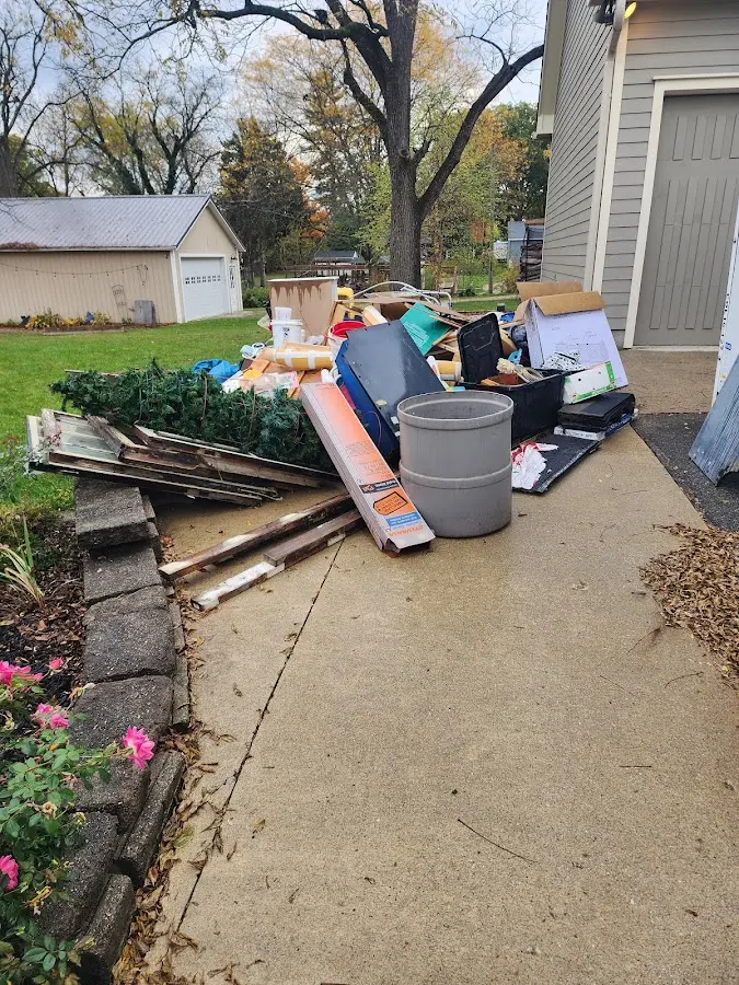 Dumpster being loaded with debris for Roofing Dumpster Rental in Lewistown